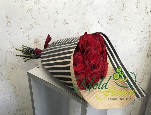 Bouquet of red roses in striped paper photo