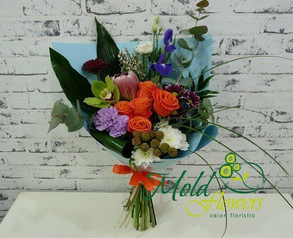 Bouquet of orange roses, green orchids, purple carnations, white eustoma, iris, chrysanthemums, and protea in blue paper (photo)