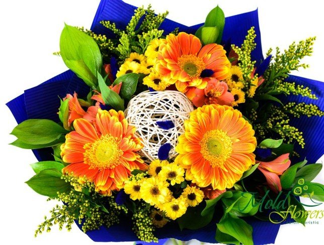 Bouquet of yellow-orange gerberas, pink alstromeria, yellow chrysanthemums, solidago, ruscus and salal leaves photo