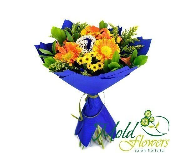 Bouquet of yellow-orange gerberas, pink alstromeria, yellow chrysanthemums, solidago, ruscus and salal leaves photo