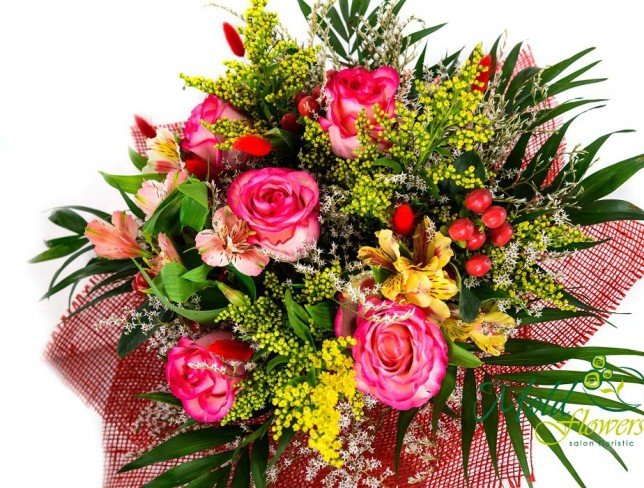 Bouquet of pink roses, solidago, red hypericum, pink and yellow alstromerias, dried flowers, chica greens in red mesh photo