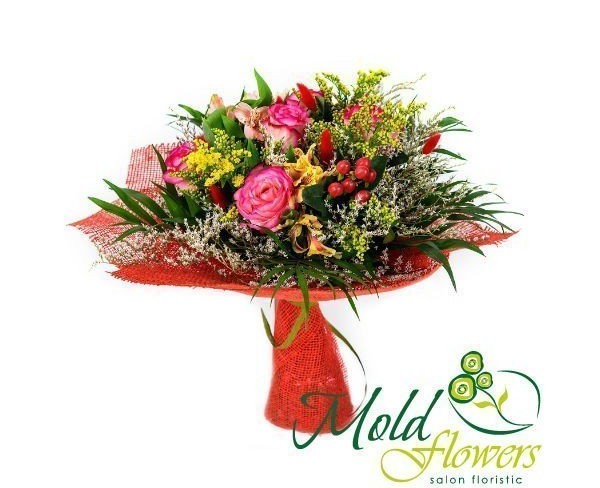 Bouquet of pink roses, solidago, red hypericum, pink and yellow alstromerias, dried flowers, chica greens in red mesh photo