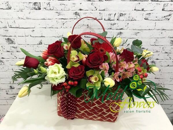 Red purse with red roses, tulips, hypericum, white tulips, green orchids, pink alstromeria photo