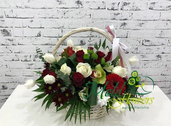 Basket with red roses, gerberas, chrysanthemums, white roses, tulips, chrysanthemums, green orchids and chrysanthemums photo