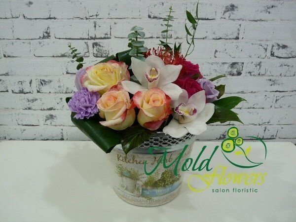 Box of white orchids, cream, purple, pink roses, leucospermum, purple carnations, aspidistra photo