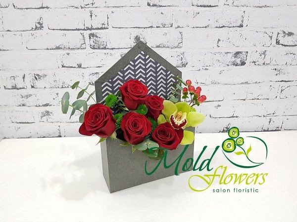 Gray envelope box with red roses, hypericum, green orchid, chrysanthemum and eucalyptus photo