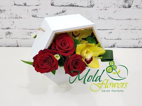 White box with red roses, yellow cymbidium orchid and green chrysanthemum photo