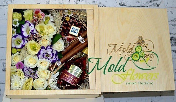 Wooden box with roses, chrysanthemum, eustoma, alstromeria, bottle of cognac, cigars and chocolates photo