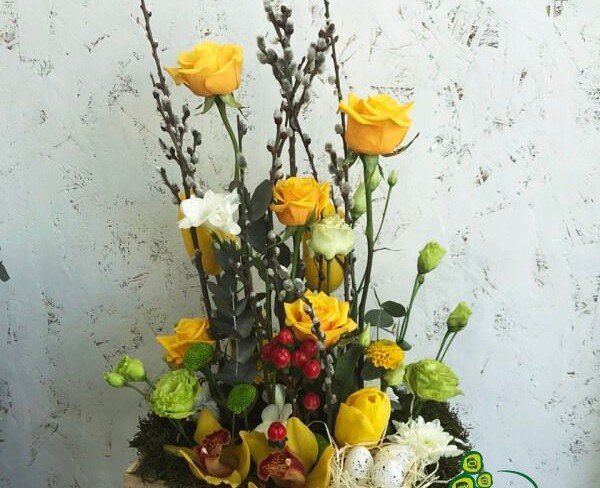 Wooden box with roses, tulips, cymbidium orchids, chrysanthemums, eustoma, hypericum, willow, decoration photo