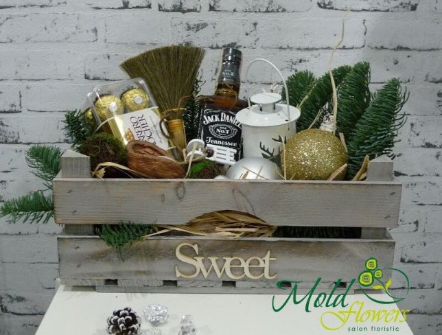 Wooden box with Christmas decor, candy, bottle of Jack Daniels photo