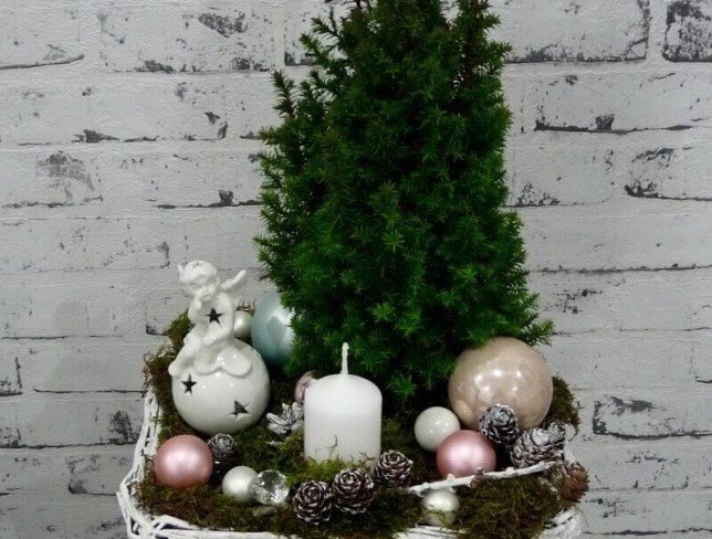 Basket with thuja, white candle, decorative angel, cones, Christmas toys photo