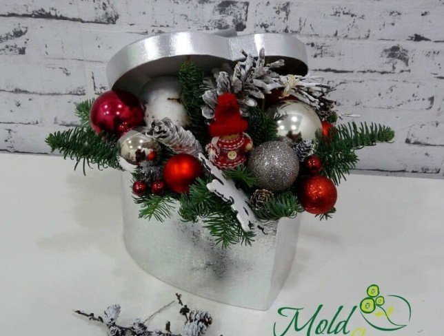 Silver heart box with sprigs of spruce, cones, Christmas toys, decorative doll and snowflake photo
