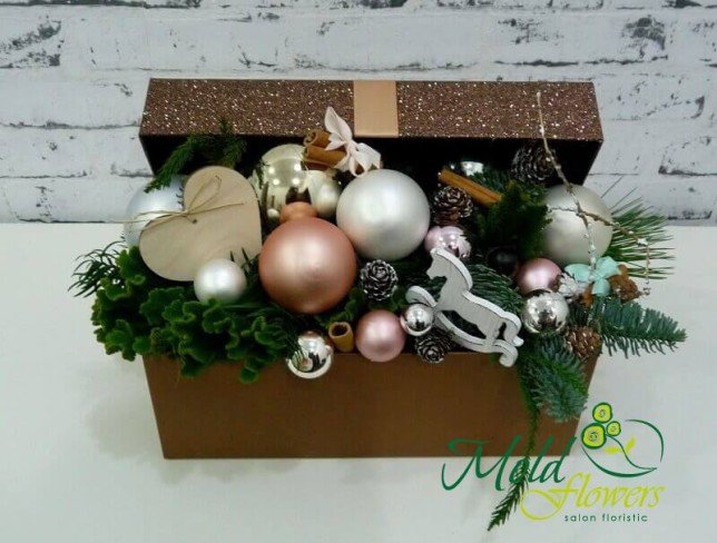 Box with sprigs of spruce, Christmas toys, cinnamon, pinecones, decorative horse and heart photo