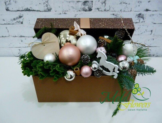 Box with sprigs of spruce, Christmas toys, cinnamon, pinecones, decorative horse and heart photo