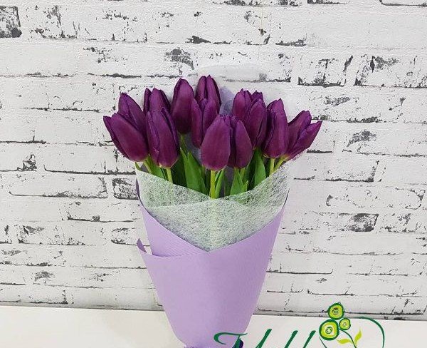 Bouquet of purple tulips in white and purple wrapping photo