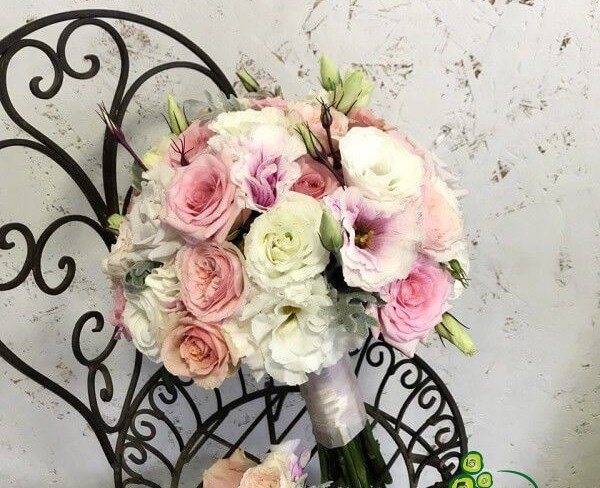 Bouquet of pink and peach roses, pink and white eustoma, boutonniere of peach roses and pink eustoma photo