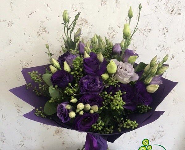 Bouquet of purple eustomas in purple paper photo
