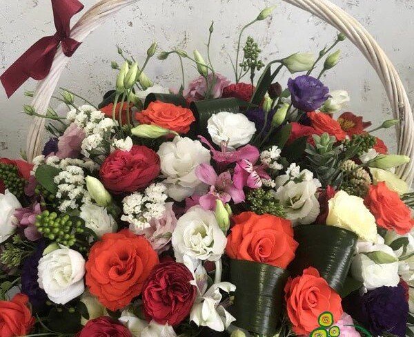 Basket with red and orange roses, white eustoma, statice, purple eustoma, pink alstromeria photo