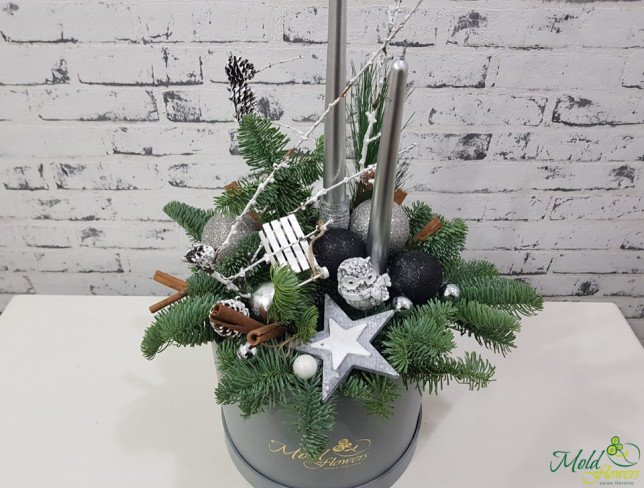 Gray box with silver candles, fir branches, pinecones, Christmas toys, cinnamon photo