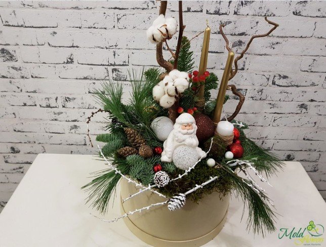 Cream box with golden candles, pinecones, cotton, Christmas toys, Santa Claus, rowan tree photo
