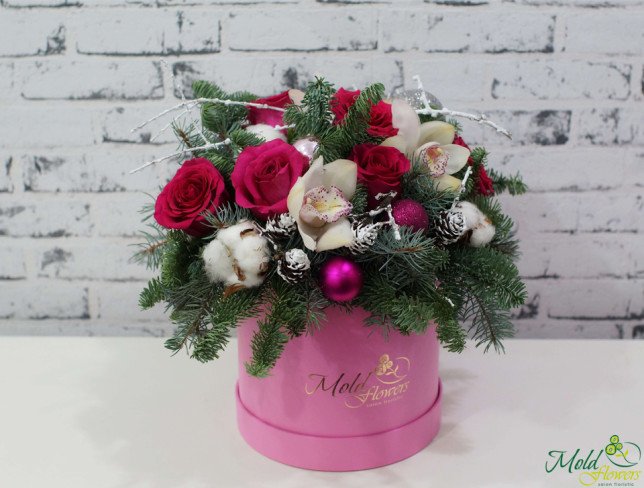 Pink box with white orchids, pink roses, Christmas toys, pinecones, cotton, sprigs of spruce photo