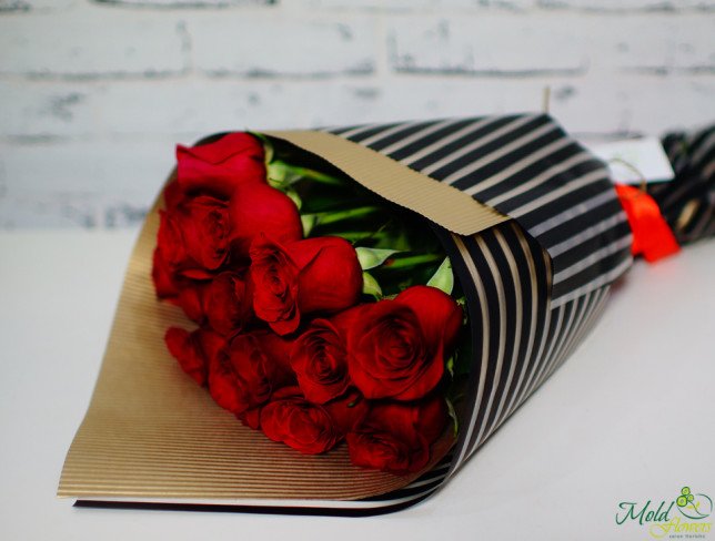Bouquet of red roses in kraft paper, black film photo