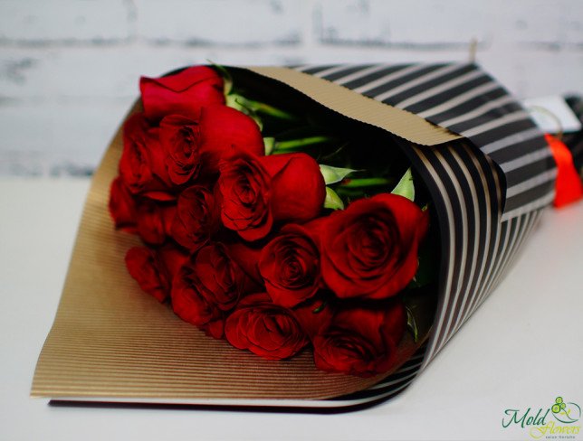 Bouquet of red roses in kraft paper, black film photo