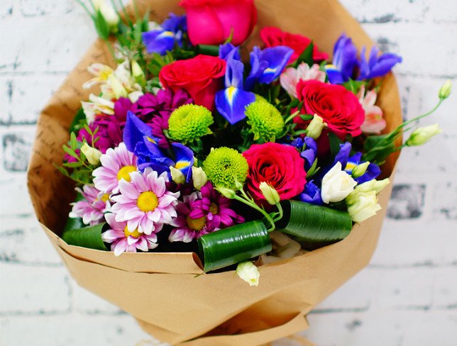 Bouquet of pink roses, chrysanthemums, alstromeria, eustomas, green chrysanthemums, purple irises, chrysanthemums photo