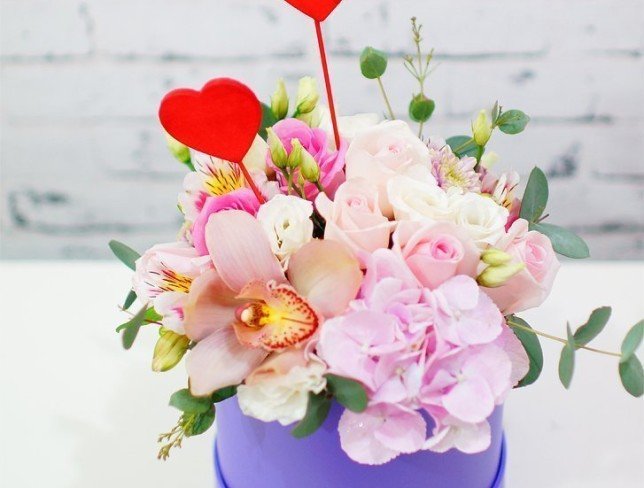 Box with pink hydrangea, roses, alstromeria, orchid, chrysanthemum, white eustoma, decorative hearts photo