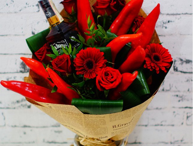 Bouquet with red roses, gerberas, bottle of Jack Daniel's, red pepper in kraft paper photo