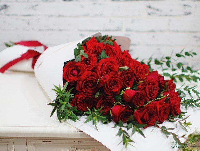 Large bouquet of red roses in white paper photo