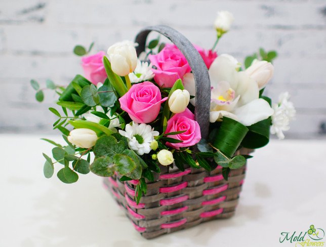 Basket with white orchids, chrysanthemums, tulips, eustomas, pink roses, eucalyptus photo