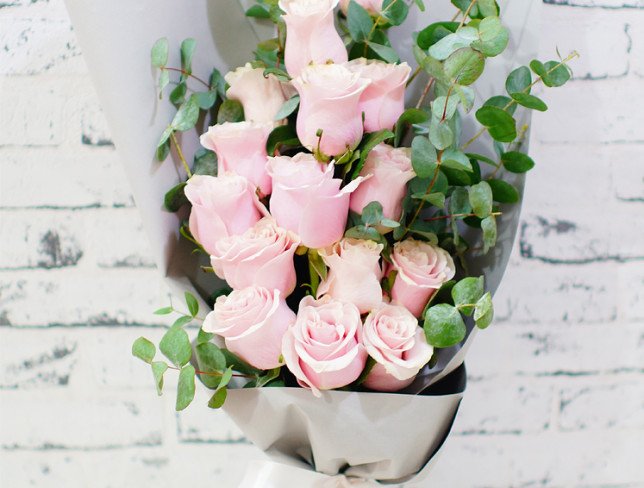 Bouquet of pink roses, eucalyptus in gray paper photo