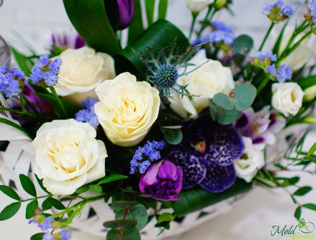 Basket with white roses, eustoma, alstromeria, purple orchid, tulips, statice, eucalyptus photo