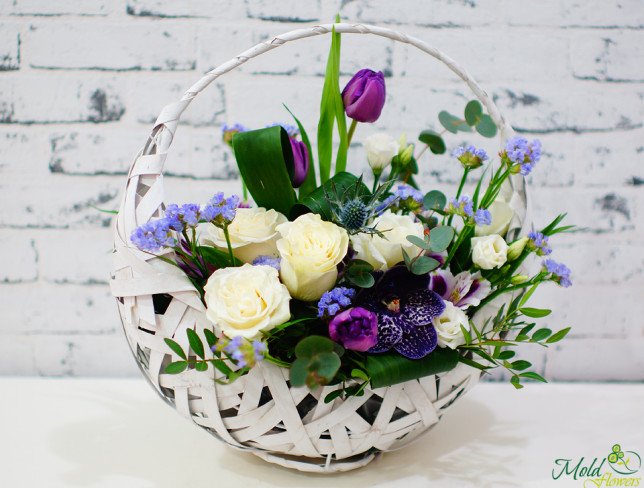 Basket with white roses, eustoma, alstromeria, purple orchid, tulips, statice, eucalyptus photo