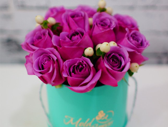 Turquoise box with purple roses and white hypericum photo