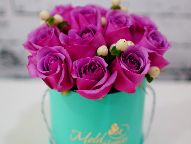 Turquoise box with purple roses and white hypericum photo