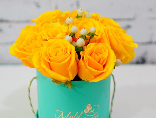Small turquoise box with yellow roses and white hypericum photo