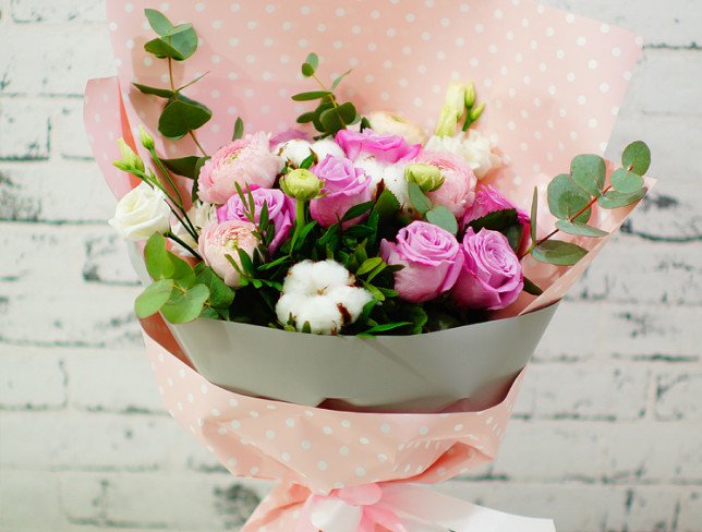 Bouquet of pink roses, ranunculus, white eustomas, cotton, eucalyptus, pistachio photo