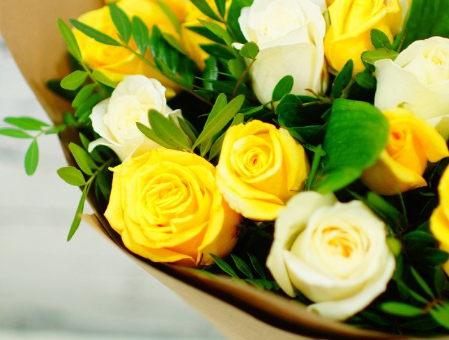 Bouquet of white and yellow roses, pistachios in kraft paper photo