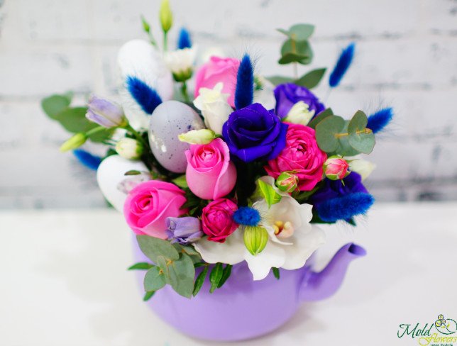 Teapot made of pink roses, bush roses, purple eustoma, spikes, white cymbidium orchid, eggs, eucalyptus photo