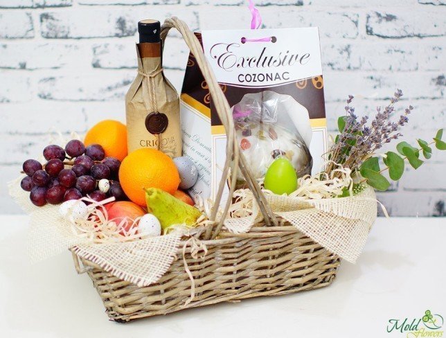 Easter basket with fruits, wine, and Easter bread photo
