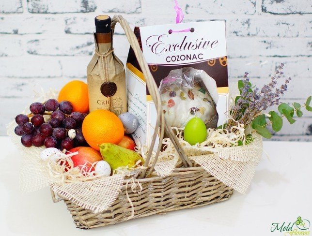 Easter basket with fruits, wine, and Easter bread photo