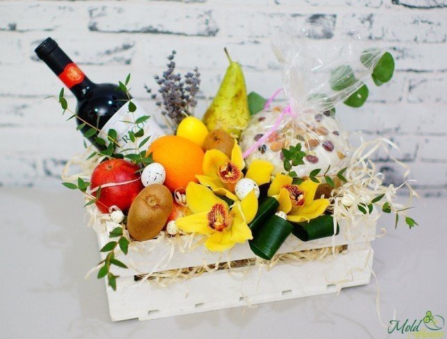 White box with orchid, fruits, bottle of wine, Easter bread photo