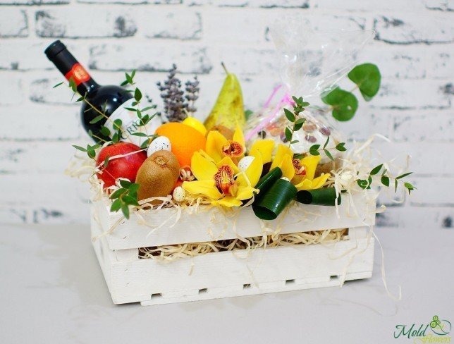 White box with orchid, fruits, bottle of wine, Easter bread photo