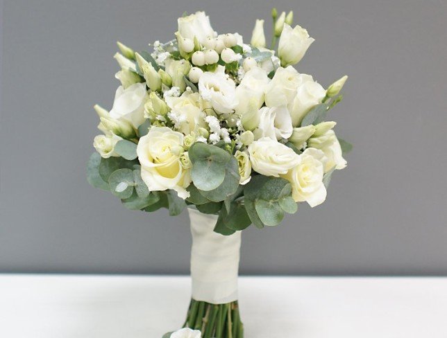 Bridal bouquet of white roses, eustoma, hypericum, gypsophila, and eucalyptus + boutonniere photo