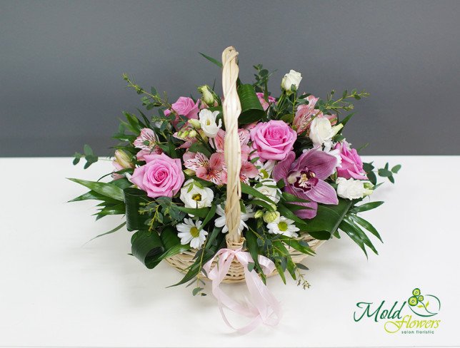Basket with pink roses, alstromeria, white roses and chrysanthemums, purple orchid and aspidistra photo