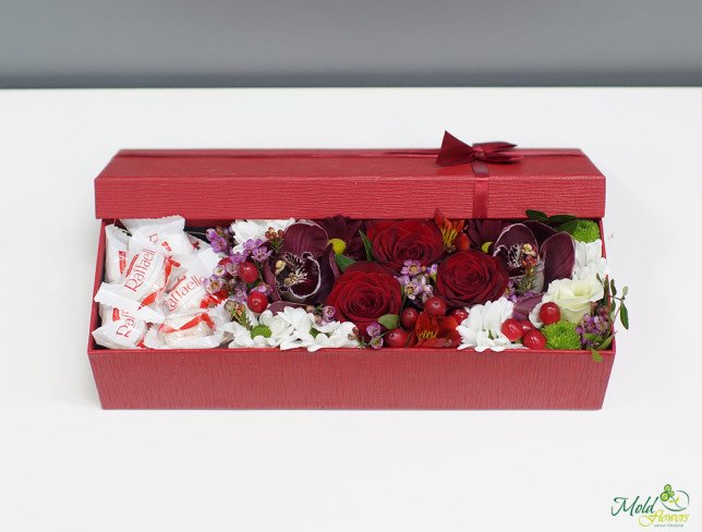 Red box with red rose, orchid, chrysanthemum, alstromeria and raffaello photo