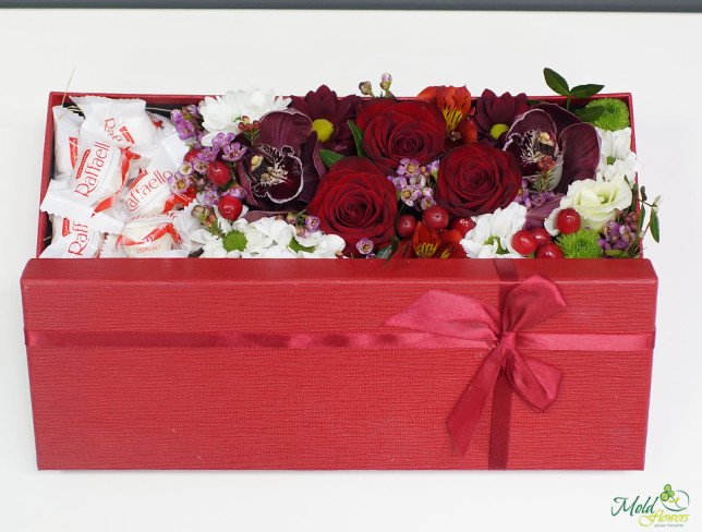 Red box with red rose, orchid, chrysanthemum, alstromeria and raffaello photo