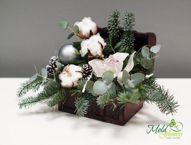 Chest with white orchid, cotton, eucalyptus, sprigs of spruce, pinecones and Christmas tree toys in silver color photo